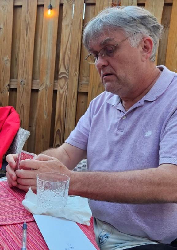 Two men sitting at a table

Description automatically generated