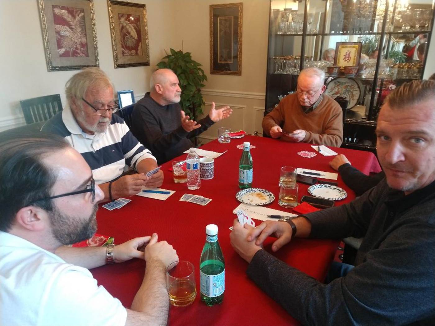 A group of men eating at a table

Description automatically generated with medium confidence